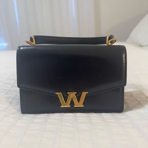 Elegant Black and Gold Crossbody Bag with Structured Design